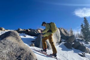A man hiking in winter.