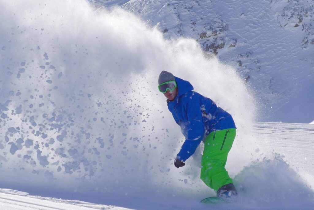 A man snowboarding in Taos, New Mexico.