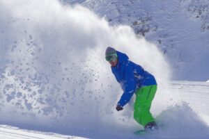 A man snowboarding in Taos, New Mexico.