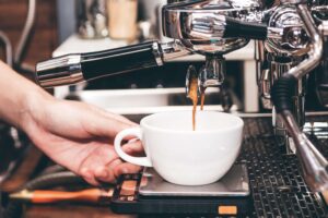A person making a New Mexico Coffee.